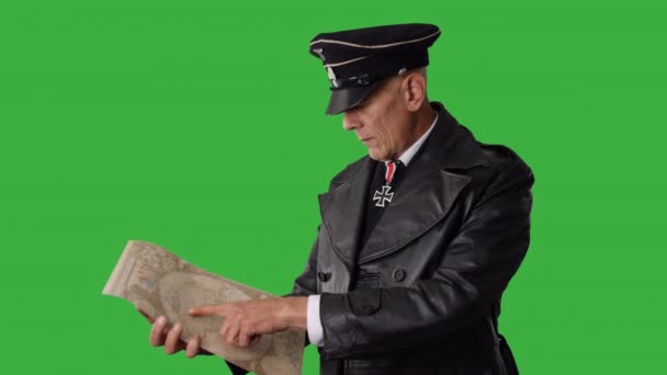 一位身着黑色制服的德国二战军官在绿屏上看地图 — 图库视频影像