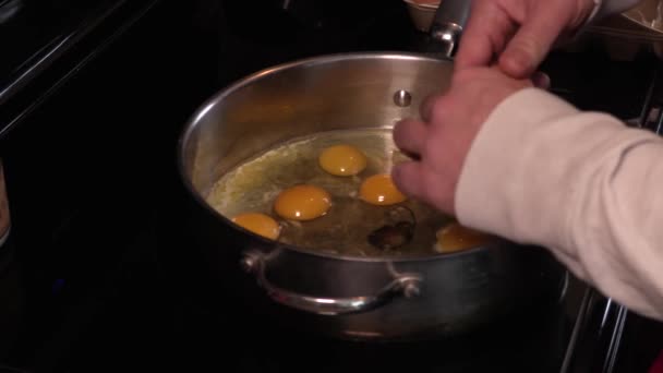 Крупный План Молодого Мужчины Разбивающего Яйцо Большую Сковороду Полную Яиц — стоковое видео
