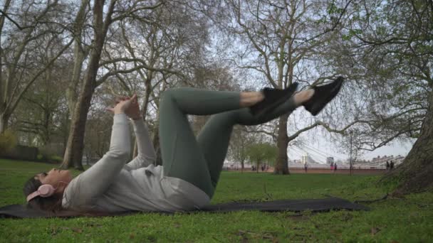 Femme Couchée Sur Dos Faisant Exercice Dans Parc — Video