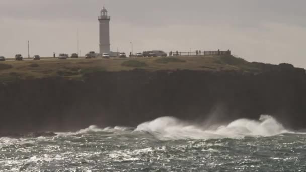 Golven Breken Rotsen Aan Voet Van Een Vuurtoren Tijdens Een — Stockvideo