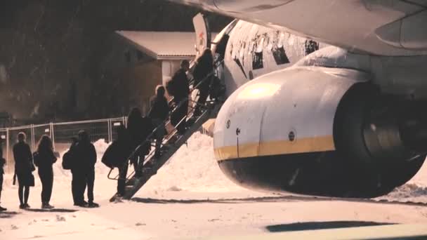 Passagiers Stappen Een Vliegtuig Een Besneeuwde Nacht Ryanair Vliegtuigmaatschappij Laaggeprijsde — Stockvideo