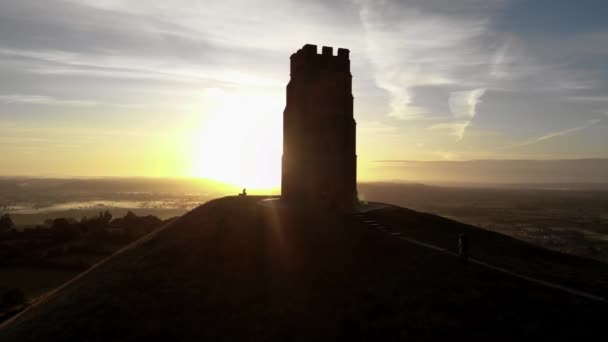 Vzrůstající Letecké Záběry Lidí Kráčejících Glastonbury Tor Při Východu Slunce — Stock video