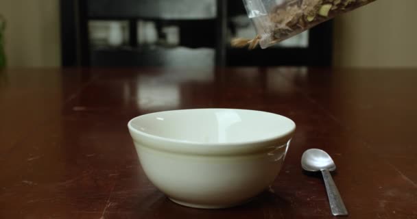 Obiloviny Pomalu Přelévající Plastového Sáčku Bílé Misky Stole — Stock video