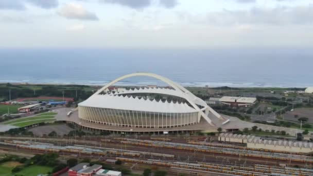 モーセ マビダ ワールドカップ競技場から空中映像がズームインし 青いインド洋と周囲の海岸線の風景を明らかにする — ストック動画