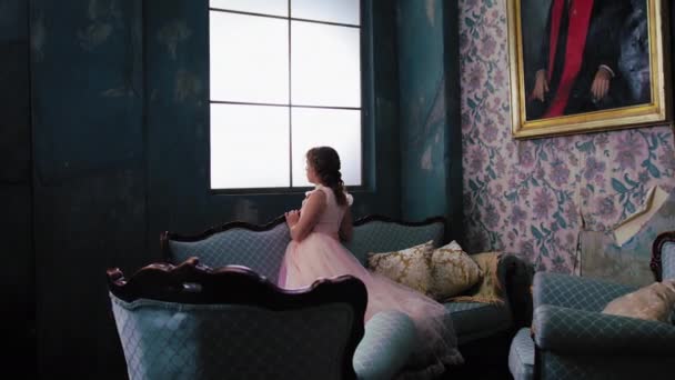 Young Girl Pink Dress Looks Her Shoulder Window Seated Blue — Stock Video