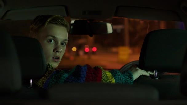 White Male Colourful Jumper Sits Car Shocked Face — Stock Video