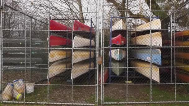 Canoes Stored Stacked Organized Locked Fence Autumn Fall Season — Stock Video