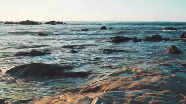 Small Ocean Waves Crushing Rocks Orange Sunset Reflected Beach Rocks — Stock Video