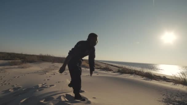 Male Dancer Moves Falls Sandy Hill Ocean Steadicam Medium Shot — Stock Video