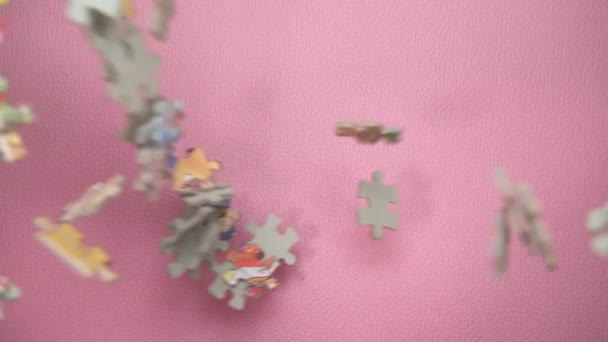 Slow Motion Puzzle Pieces Falling Pink Surface Ovanifrån — Stockvideo