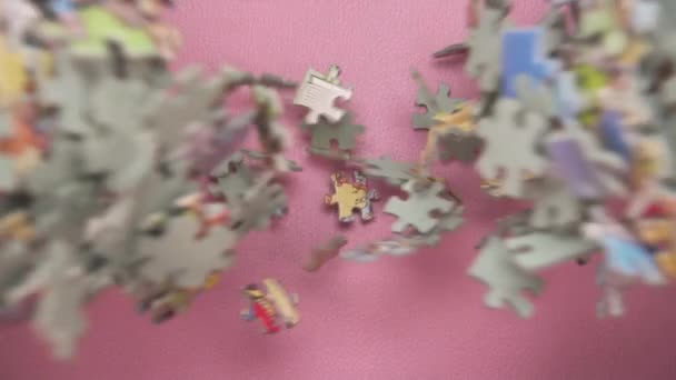 Many Puzzle Pieces Falling Pink Background Overhead View — Stock Video