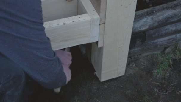 Carpenter Digging Dirt Out Wooden Frame Adjust Height Level Using — Stock Video