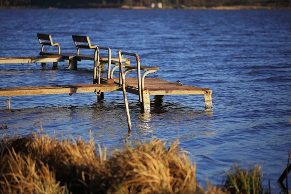 Empty old footbridges with benches on a lake Stock Image