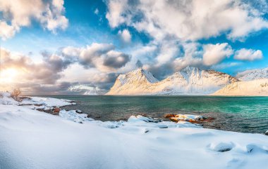 Stunning winter view of Vik beach during sunset with lots of snow  and snowy  mountain peaks near Leknes.  Location: Leknes, Vestvagoy, Lofotens, Norway clipart