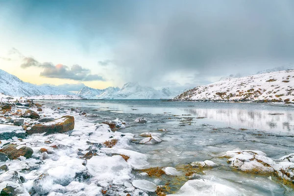 Torsfjorden fiyordunun muhteşem sabah manzarası. Arka planda çatlak buz ve karlı dağ zirveleri var. Konum: Ramberg, Flakstadoya Adası, Lofoten; Norveç, Avrupa