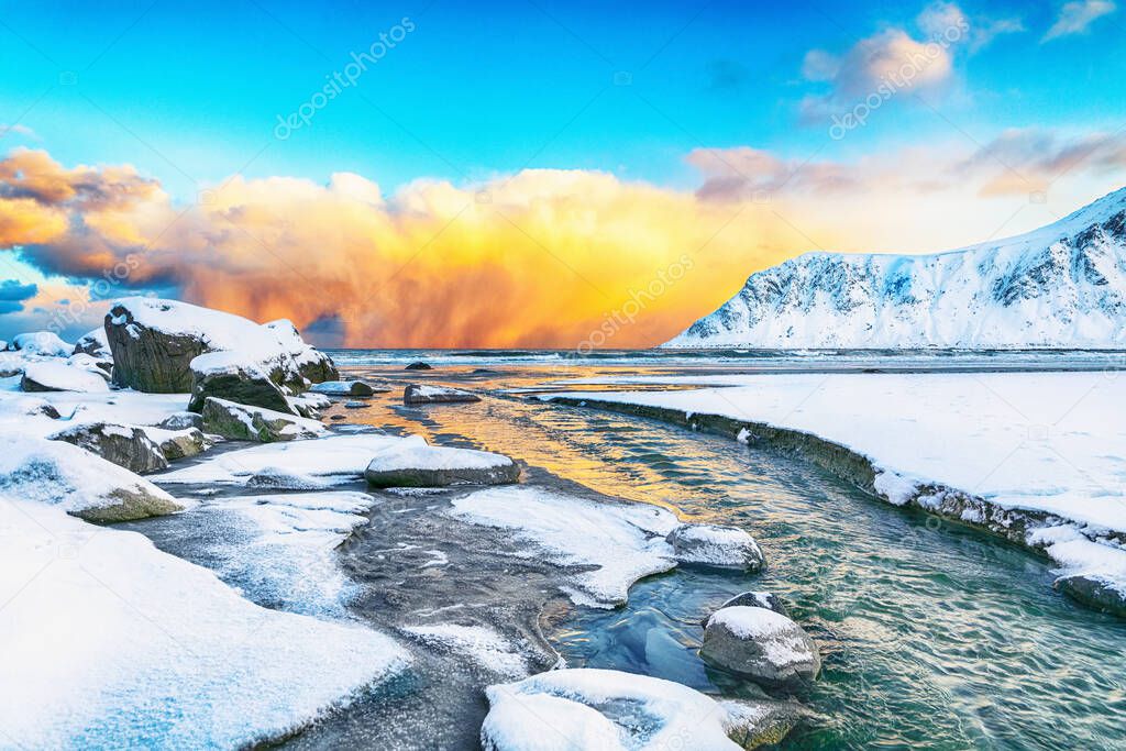 Fabulous winter scenery on Skagsanden beach with illuminated clouds during sunrise. Popular tourist destination. Location: Flakstadoya island, Lofoten; Norway, Europe