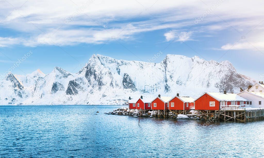 Traditional Norwegian red wooden houses (rorbuer) on the shore of  Reinefjorden near Hamnoy village.  Location: Hamnoy, Lofoten; Norway, Europe