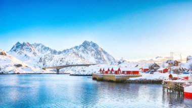 Winter view of small fishing village on Sundstraumen strait and Kakern Bridge that separates Moskenesoya and Flakstadoya islands. Location: Flakstadoya island, Lofoten; Norway, Europe clipart