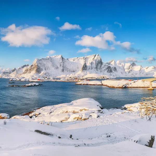 Arka plandaki Hamnoy ve karlı dağlardan Reine ve Sakrisoya köylerinin muhteşem kış manzarası. Konum: Olenilsoya Adası, Lofoten; Norveç, Avrupa