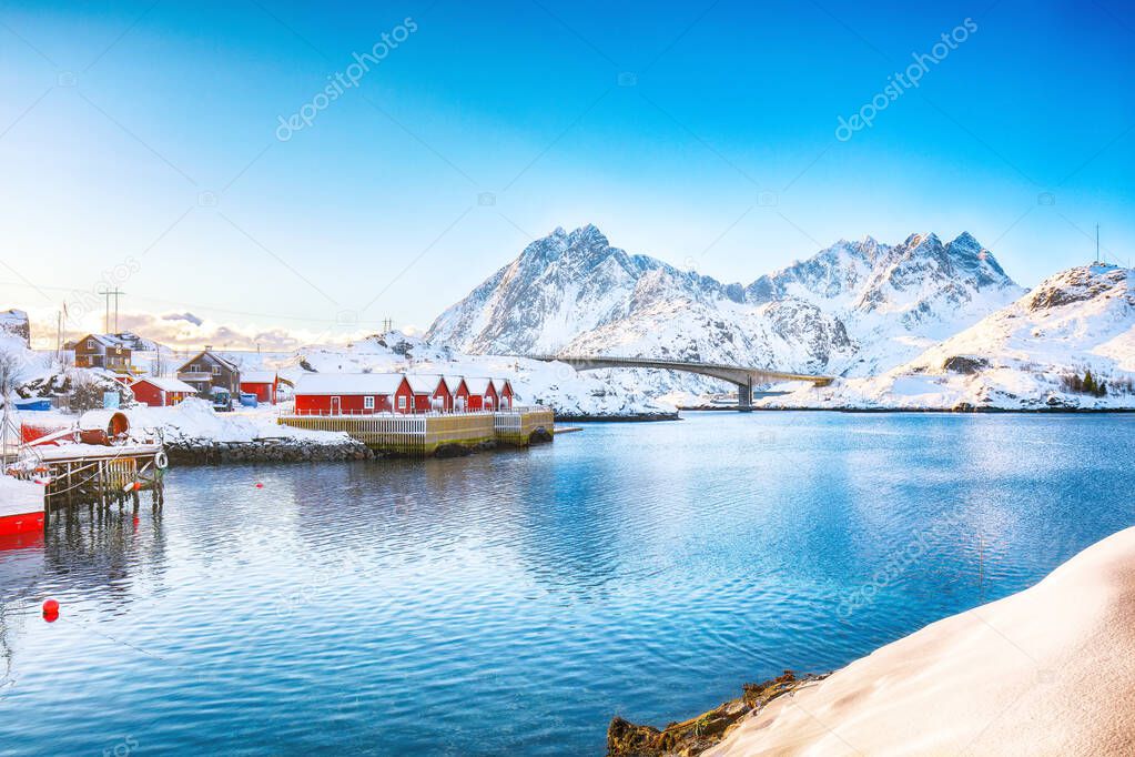 Winter view of small fishing village on Sundstraumen strait and Kakern Bridge that separates Moskenesoya and Flakstadoya islands. Location: Flakstadoya island, Lofoten; Norway, Europe