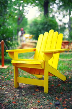 yellow wooden chair on the grass