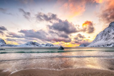 Amazing winter scenery with Haukland beach during sunset and snowy  mountain peaks near Leknes.  Location: Leknes, Vestvagoy, Lofotens, Norway