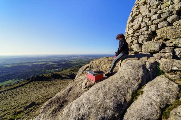 Woman at the top of the mountain contemplating the views after reaching the top. Madrid.