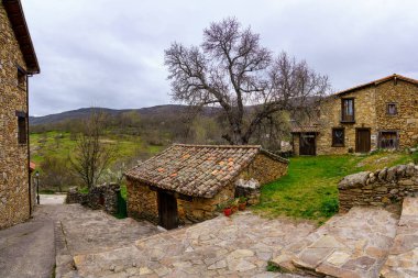 Small stone house in an old town with typical stone houses and stairs in the alley. Horcajuelo Madrid. Spain.