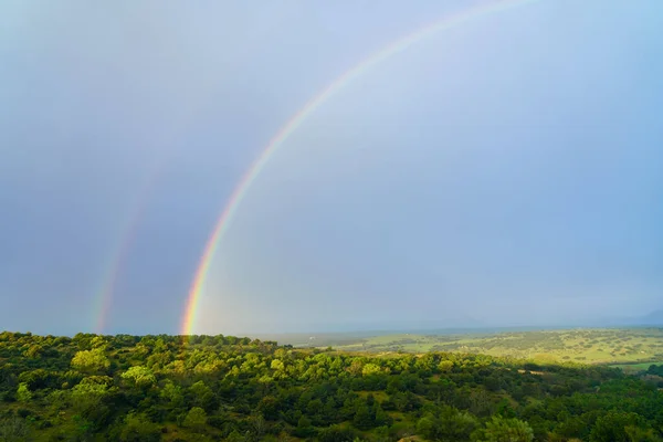 Rainbow in the field after the rain storm in spring. Madrid