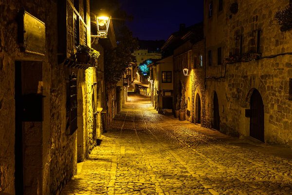 Main street of old stone town at night. Santillana del Mar, Santander.