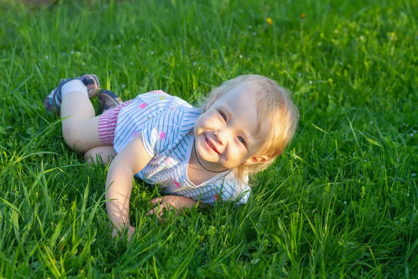 Όμορφο Κοριτσάκι Ετών Ξαπλώνει Στο Γρασίδι Καλοκαίρι Και Χαμογελά — Φωτογραφία Αρχείου