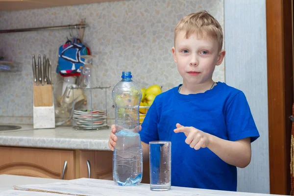 Chłopiec Lat Wlewa Wodę Plastikowej Butelki Szklanki Domu Kuchni — Zdjęcie stockowe