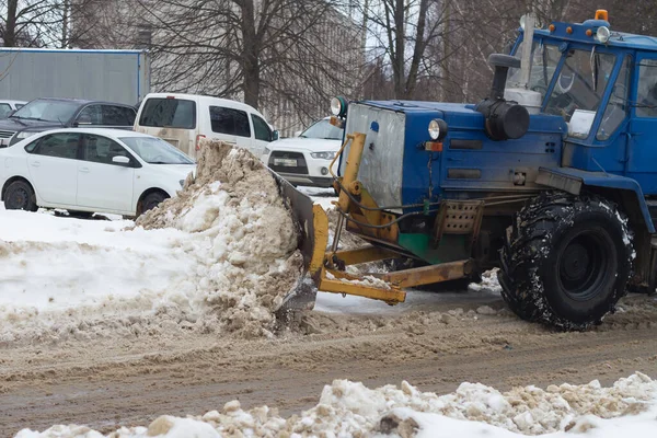 Snow removal from the streets with the help of special equipment in winter.