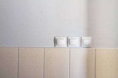 Duvardaki ışıkları açıp kapamak için üç düğme..