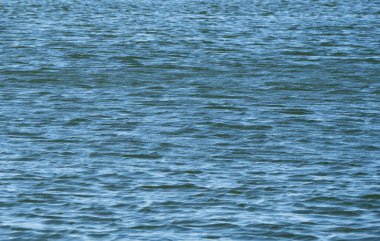 Doğal arka plan. Küçük dalgalarla mavimsi su yüzeyi.