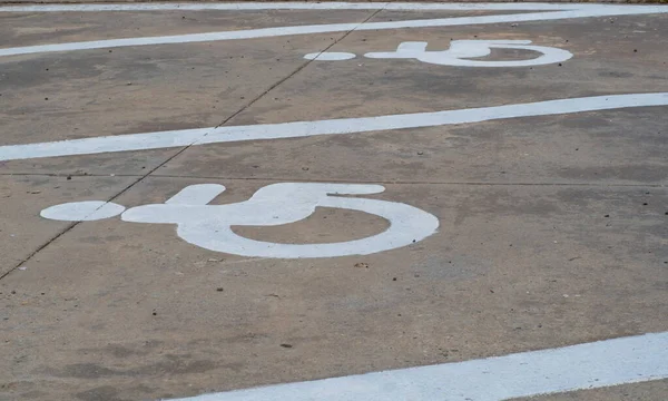 The symbol is a parking space for the disabled. Close-up of international markings for disabled parking spaces.