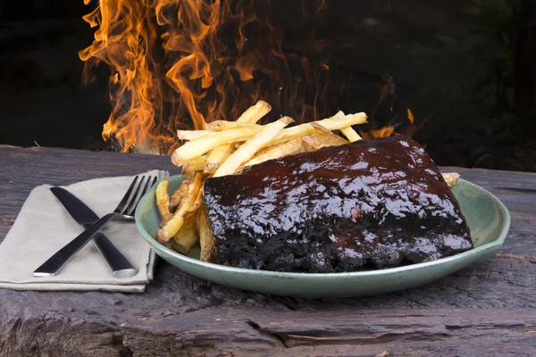 Pork ribs back with french fries — Stock Photo, Image