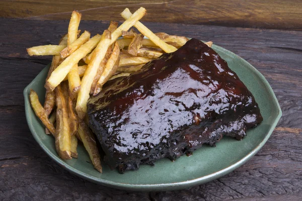 Pork ribs back with french fries — Stock Photo, Image