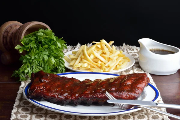 Pork ribs with fries — Stock Photo, Image