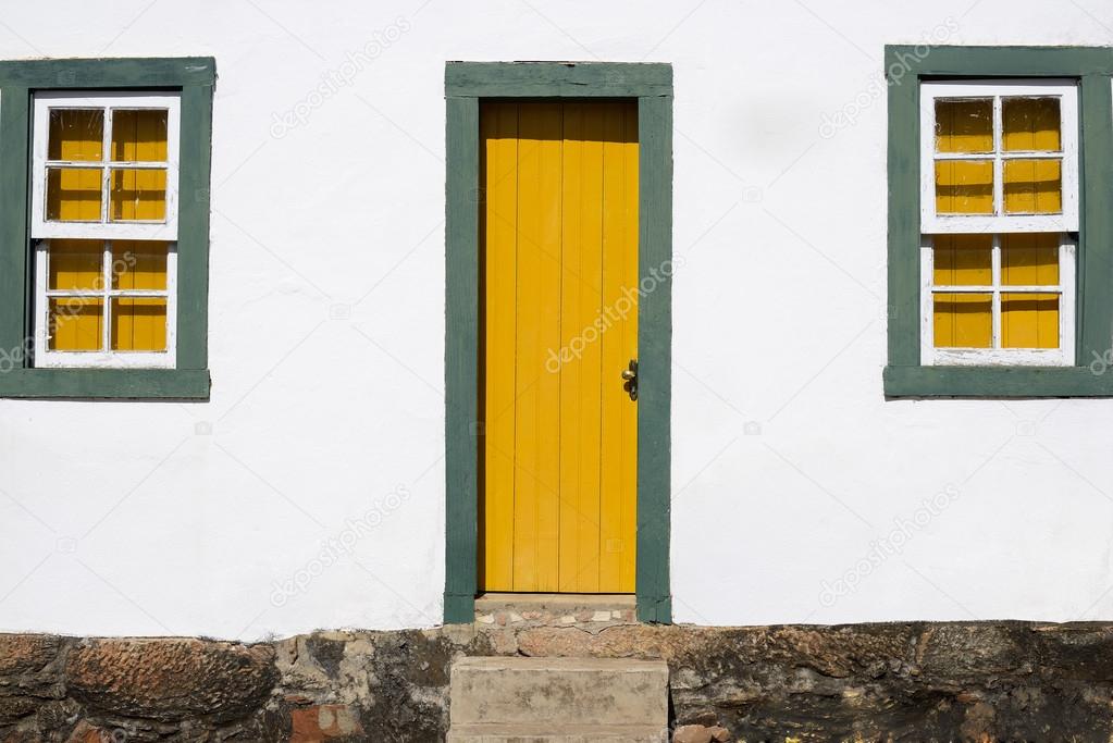 Colonial House With Yellow and Green Door