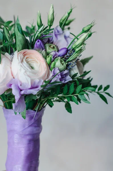 Bellissimo bouquet da sposa rustico di fiori di lavanda ranuncolo viola e bianco con nastro lilla satinato su sfondo bianco Foto Stock