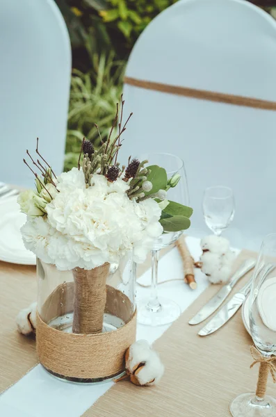 Winter wedding decoration with cotton flower in banquet. Bridal bouquet of white carnations, peony, roses flowers in vase on table craft background. Lovely nosegay. floral . Twin . Text, copy space