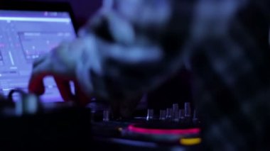 Hands of DJ which mixes music tracks PC mixer in nightclub 4