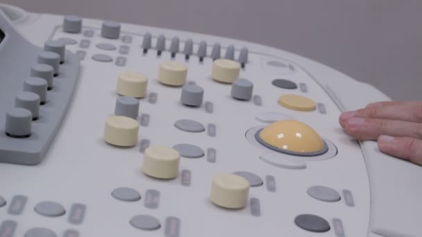 The doctor presses a buttons Ultrasonography medical equipment keyboard — Stock Video