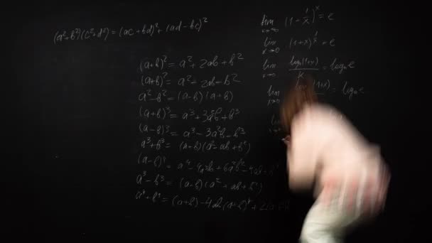 Time lapse of a female student writing algebra formulas and drawing graphics on blackboard — Vídeos de Stock