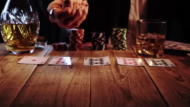 Closeup view of man throwing two dices during casino craps game sitting in a bar in slow motion — Wideo stockowe