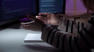 Bilgisayarın önünde oturan ve ayrıntıları yakın planda tartışan programcıların süreci