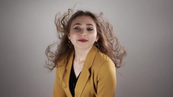 Young woman is raising her head up in slow motion and posing on a white background — Stock Video