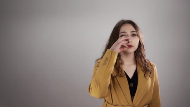 Portret van een jonge vrouw die haar lippen ritst om te laten zien dat ze een geheim kan bewaren in een slow motion — Stockvideo