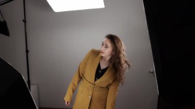 Photo model is shaking her head with long fluttering hair during footage in slow motion